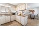 A sunlit kitchen features granite countertops, white cabinets, and an adjoining dining area at 908 N 24Th St, Las Vegas, NV 89101