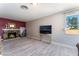 Open living room featuring a stone fireplace, a flat-screen TV, and bright natural light at 908 N 24Th St, Las Vegas, NV 89101