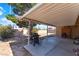 View of the backyard patio featuring a cover, gas grill, brick accent, and outdoor seating at 908 N 24Th St, Las Vegas, NV 89101