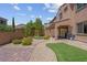 Desert landscaped backyard with a covered patio, artificial turf and a grilling area at 9643 Wildflower Vista Ave, Las Vegas, NV 89166