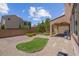 Private backyard featuring desert landscaping, artificial grass, and a covered patio at 9643 Wildflower Vista Ave, Las Vegas, NV 89166
