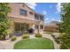 Landscaped backyard featuring artificial turf, patio, and desert landscaping at 9643 Wildflower Vista Ave, Las Vegas, NV 89166