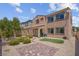 Exterior view of a home featuring desert landscaping, covered patio, and well maintained lawn at 9643 Wildflower Vista Ave, Las Vegas, NV 89166