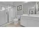 Bright bathroom featuring tiled floors, glass shower, and a white vanity with countertop space at 9643 Wildflower Vista Ave, Las Vegas, NV 89166