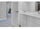 View into the bathroom with double vanity, white cabinets, and neutral tile at 9643 Wildflower Vista Ave, Las Vegas, NV 89166