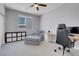 Comfortable bedroom featuring a ceiling fan, window and seating area at 9643 Wildflower Vista Ave, Las Vegas, NV 89166