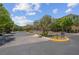 Welcoming community entrance featuring stone gate, mature trees, and well maintained landscaping at 9643 Wildflower Vista Ave, Las Vegas, NV 89166