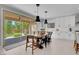 Cozy dining area with backyard views, pendant lighting, and a stylish wood table and chairs at 9643 Wildflower Vista Ave, Las Vegas, NV 89166