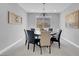 Dining room featuring a round table with seating, modern light fixture and neutral decor at 9643 Wildflower Vista Ave, Las Vegas, NV 89166