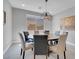 Dining room with a round table, seating for six, and a stylish pendant light fixture at 9643 Wildflower Vista Ave, Las Vegas, NV 89166