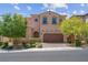 Charming two-story home with a well-maintained front yard, mature trees, and a two-car garage at 9643 Wildflower Vista Ave, Las Vegas, NV 89166