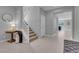 Open-concept foyer featuring light wood floors, a staircase, and views into other rooms at 9643 Wildflower Vista Ave, Las Vegas, NV 89166