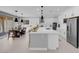 Spacious kitchen featuring a large island, stainless steel appliances, and an adjacent dining area at 9643 Wildflower Vista Ave, Las Vegas, NV 89166