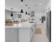 Modern kitchen boasting a large island, stainless steel appliances, and sleek white cabinetry at 9643 Wildflower Vista Ave, Las Vegas, NV 89166