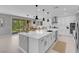 Spacious modern kitchen with a large center island, white cabinetry, and stainless steel appliances at 9643 Wildflower Vista Ave, Las Vegas, NV 89166