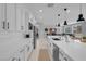 Modern kitchen with sleek white cabinets, stainless steel appliances, and an open layout at 9643 Wildflower Vista Ave, Las Vegas, NV 89166