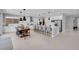 Open-concept kitchen featuring a large island with barstool seating, a dining area and modern appliances at 9643 Wildflower Vista Ave, Las Vegas, NV 89166