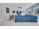 Cozy living area with a large sectional sofa, accent chairs, and a modern entertainment center at 9643 Wildflower Vista Ave, Las Vegas, NV 89166