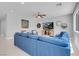 Bright living room with a comfortable blue sofa, stylish decor, and plenty of natural light at 9643 Wildflower Vista Ave, Las Vegas, NV 89166