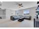 Spacious loft with a sectional sofa, ceiling fan, and bright windows at 9643 Wildflower Vista Ave, Las Vegas, NV 89166