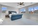 Bright primary bedroom with large windows, carpet, and a blue upholstered bed at 9643 Wildflower Vista Ave, Las Vegas, NV 89166