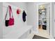 Functional mud room with bench seating, hooks, and access to a storage pantry at 9643 Wildflower Vista Ave, Las Vegas, NV 89166