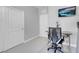 Bright office featuring a gray desk, chair and a TV at 9643 Wildflower Vista Ave, Las Vegas, NV 89166