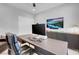 Comfortable home office featuring a large dark wood desk and entertainment center with a wall-mounted television at 9643 Wildflower Vista Ave, Las Vegas, NV 89166