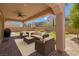 Inviting covered patio with stylish outdoor seating and a ceiling fan for comfortable relaxation at 9643 Wildflower Vista Ave, Las Vegas, NV 89166