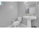 Bright powder room featuring a pedestal sink, toilet, and neutral paint at 9643 Wildflower Vista Ave, Las Vegas, NV 89166