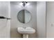 Powder room features a pedestal sink, modern light fixture, and neutral decor at 9766 Marcelline Ave, Las Vegas, NV 89148