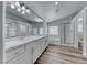 Bright bathroom with double vanity, modern fixtures, separate tub, and glass-enclosed shower at 9766 Marcelline Ave, Las Vegas, NV 89148