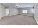 Spacious bedroom with neutral carpet, fan, high ceilings, and natural light from large windows at 9766 Marcelline Ave, Las Vegas, NV 89148