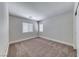 Empty bedroom features neutral carpet, natural light from large windows, and neutral walls at 9766 Marcelline Ave, Las Vegas, NV 89148