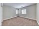 Bright bedroom features neutral walls, carpet, and two windows that allow for natural light at 9766 Marcelline Ave, Las Vegas, NV 89148