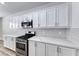 Modern kitchen featuring stainless steel appliances, quartz countertops and a tiled backsplash at 9766 Marcelline Ave, Las Vegas, NV 89148