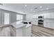 This modern kitchen offers stainless steel appliances, a breakfast bar, and quartz countertops at 9766 Marcelline Ave, Las Vegas, NV 89148