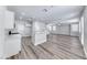 Expansive living area featuring modern flooring, a ceiling fan and a kitchen island at 9766 Marcelline Ave, Las Vegas, NV 89148
