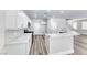 Open floor plan kitchen with stainless steel appliances, quartz countertops and modern flooring at 9766 Marcelline Ave, Las Vegas, NV 89148