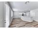 Bright living area with sleek, modern flooring and sliding glass doors to the outside at 9766 Marcelline Ave, Las Vegas, NV 89148