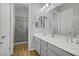 Bathroom with double sinks, and a glass-enclosed shower with tiled walls at 9779 Mosaic Canyon Ct, Las Vegas, NV 89149