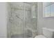 Shower with glass door, shower seat, and built-in shelving at 9779 Mosaic Canyon Ct, Las Vegas, NV 89149