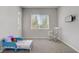 Charming bedroom with plush carpet, rocking chair, and natural light from two windows at 9779 Mosaic Canyon Ct, Las Vegas, NV 89149