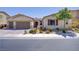 Attractive single-story home with a three-car garage, lush landscaping, and a beautifully maintained front yard at 9779 Mosaic Canyon Ct, Las Vegas, NV 89149