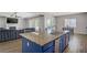 Open-concept kitchen and living area with an island, modern appliances, and seamless integration for entertaining at 9779 Mosaic Canyon Ct, Las Vegas, NV 89149