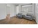 Living room features hardwood floors and two gray chairs at 9779 Mosaic Canyon Ct, Las Vegas, NV 89149