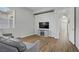 Living room with tile floors, gray walls, and a TV and console table at 9779 Mosaic Canyon Ct, Las Vegas, NV 89149