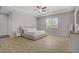 Spacious main bedroom featuring tray ceiling, wood-look tile flooring, and large window at 9779 Mosaic Canyon Ct, Las Vegas, NV 89149