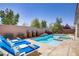 Sparkling in-ground pool featuring spa, waterfall, and lounge chairs at 9779 Mosaic Canyon Ct, Las Vegas, NV 89149
