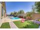 Sparkling pool and spa with a luxurious patio area, perfect for relaxing and entertaining in your backyard oasis at 9779 Mosaic Canyon Ct, Las Vegas, NV 89149